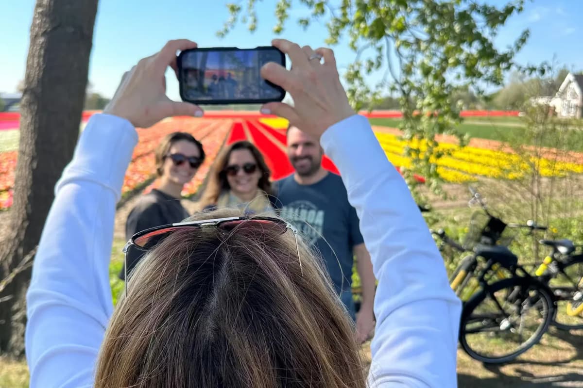Family cycling through blooming tulip fields