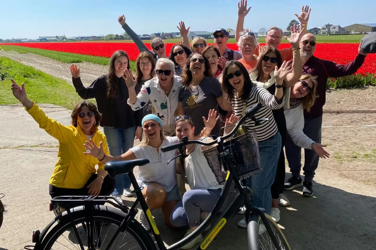 Group photo in front of tulip field during bicycle tour